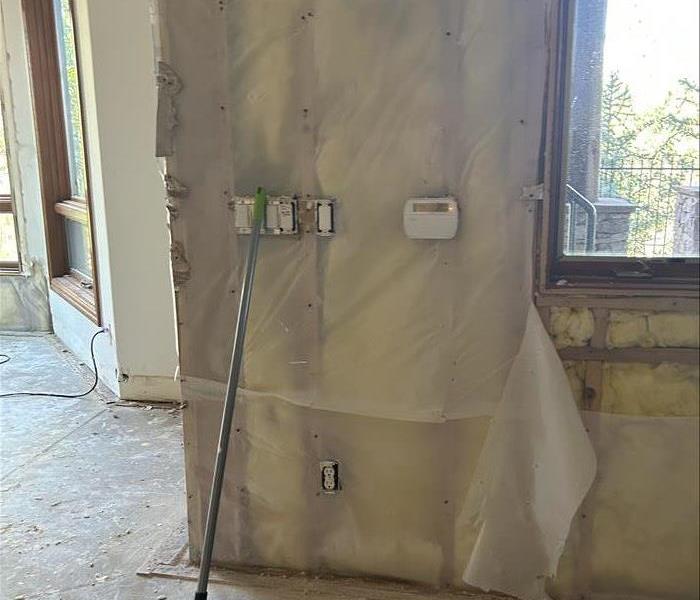 Wall with exposed insulation due to the drywall being removed.